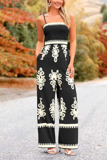 Woman in black and cream damask print jumpsuit