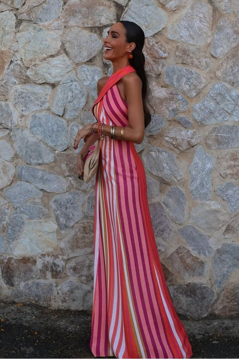 A woman wearing a striped pink and orange linen maxi dress.