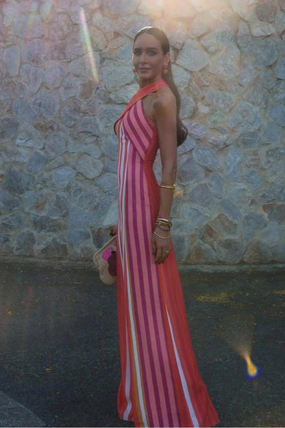 A woman wearing a striped pink and orange linen maxi dress.