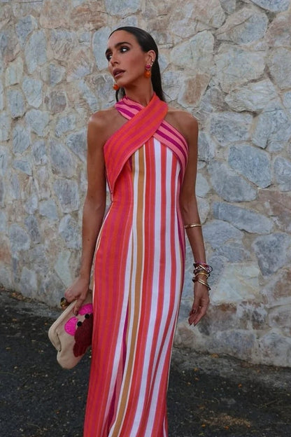 A woman wearing a striped pink and orange linen maxi dress.