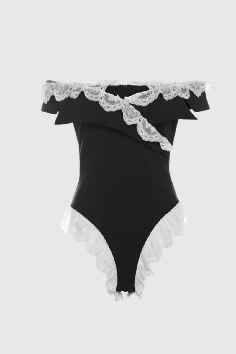 Woman in black satin bodysuit with white lace trim