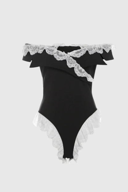 Woman in black satin bodysuit with white lace trim
