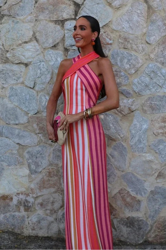 A woman wearing a striped pink and orange linen maxi dress.