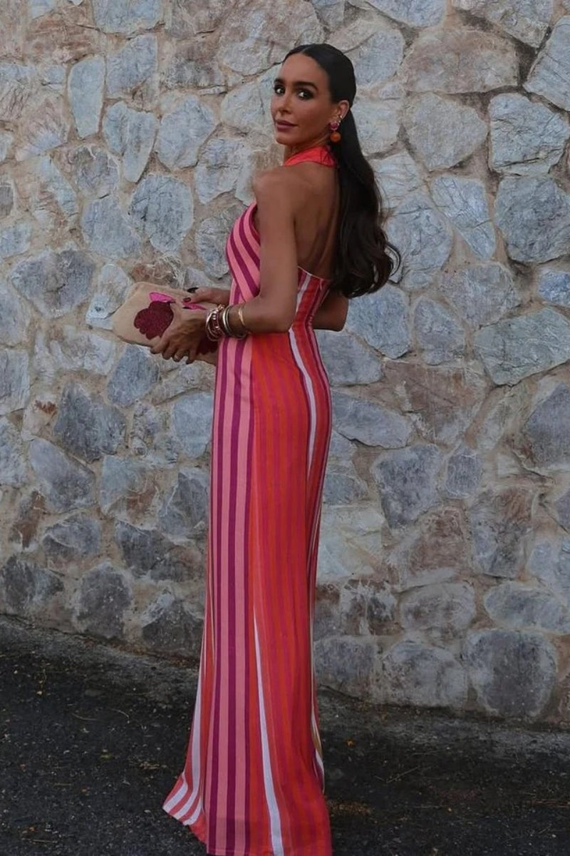 A woman wearing a striped pink and orange linen maxi dress.