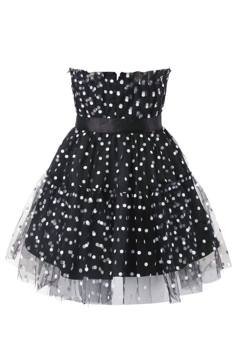 Woman in black and white polka dot tulle mini dress with belt