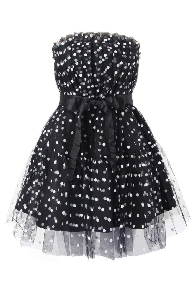 Woman in black and white polka dot tulle mini dress with belt