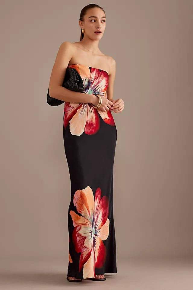 Woman in black strapless satin maxi dress with floral print