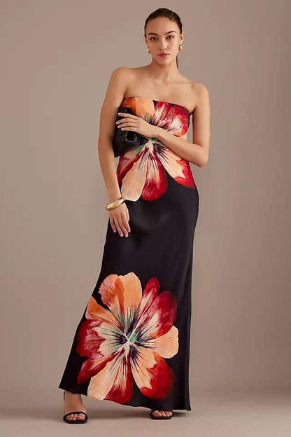 Woman in black strapless satin maxi dress with floral print