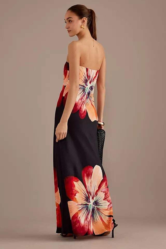 Woman in black strapless satin maxi dress with floral print
