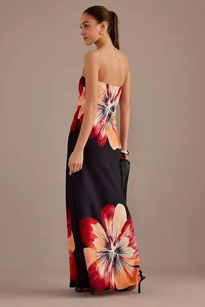 Woman in black strapless satin maxi dress with floral print