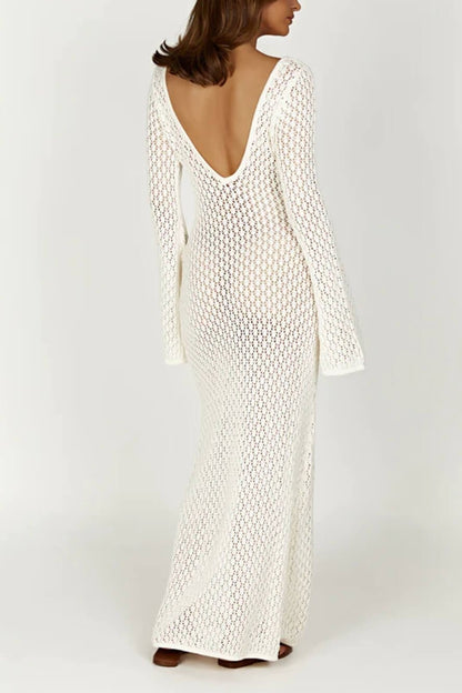 Woman wearing a long white crochet dress with a light blue purse.