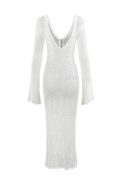 Woman wearing a long white crochet dress with a light blue purse.