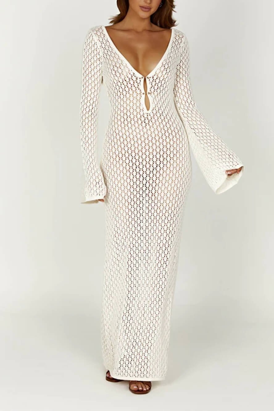 Woman wearing a long white crochet dress with a light blue purse.