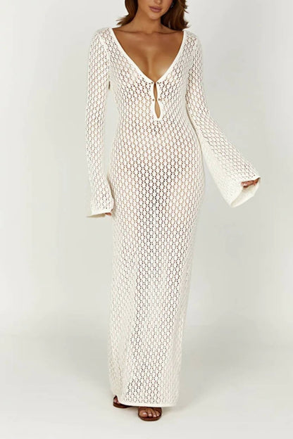 Woman wearing a long white crochet dress with a light blue purse.
