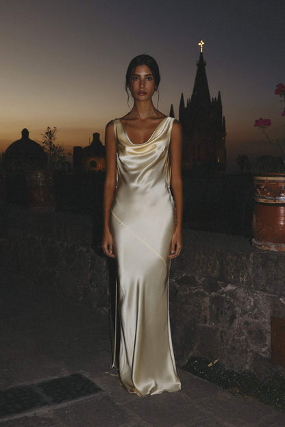 Woman wearing ivory silk cowl neck slip dress