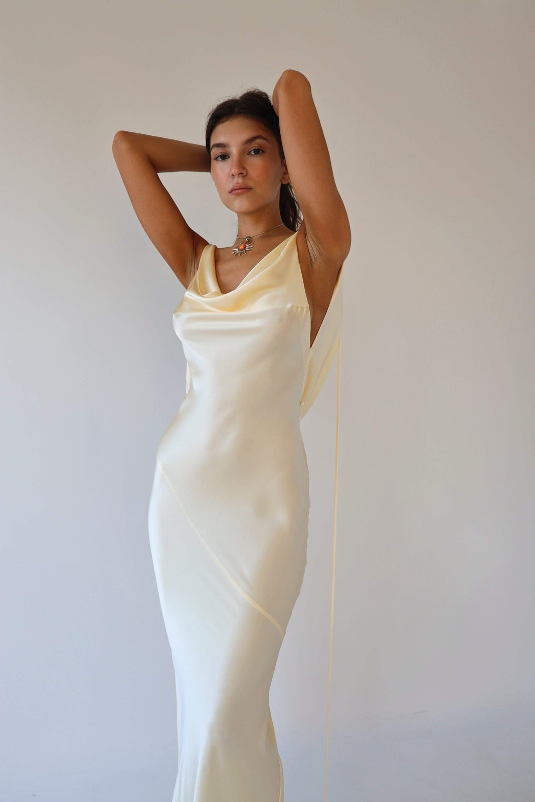 Woman wearing ivory silk cowl neck slip dress