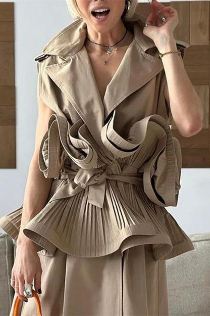 Woman wearing tan sleeveless trench vest with orange purse
