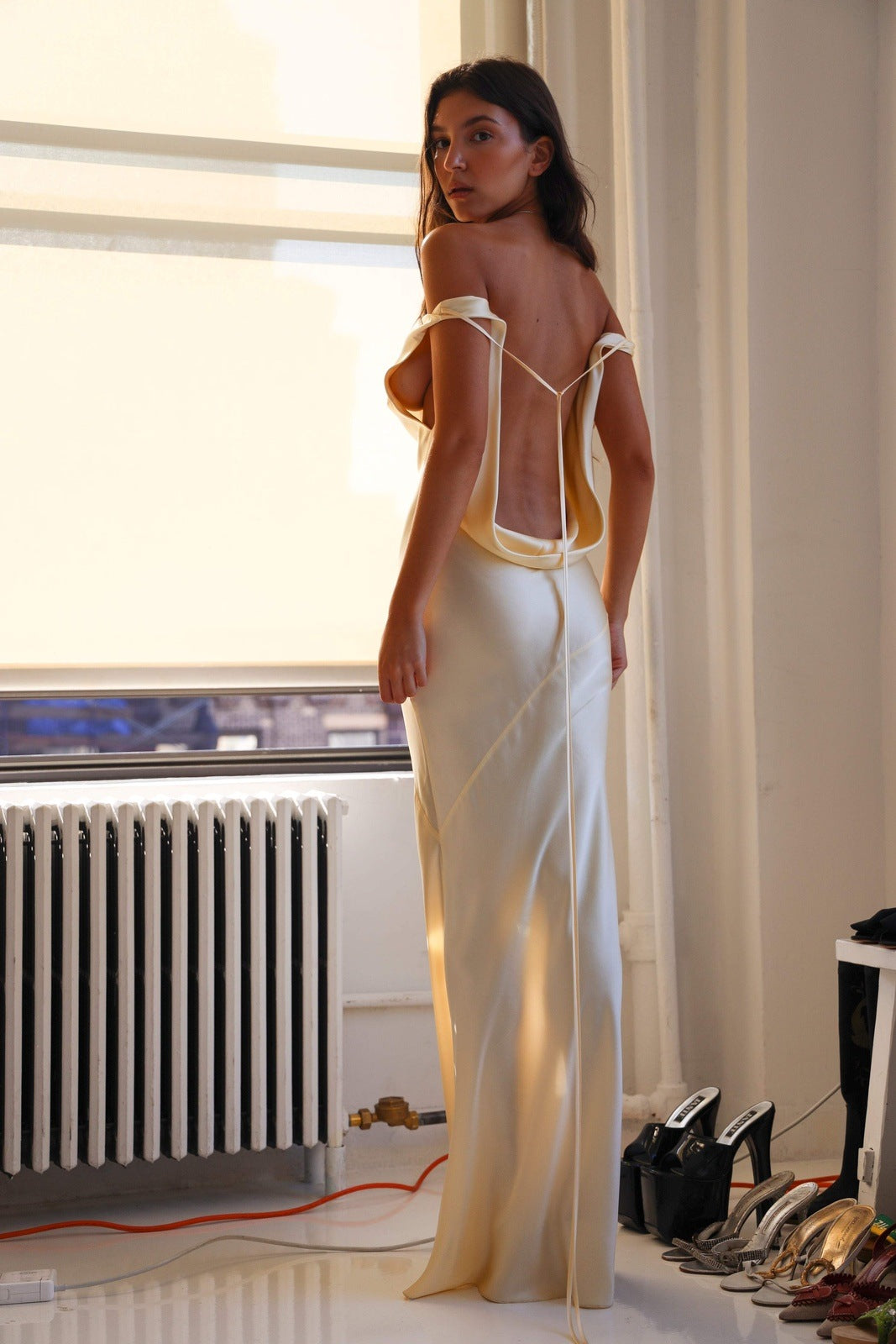 Woman wearing ivory silk cowl neck slip dress