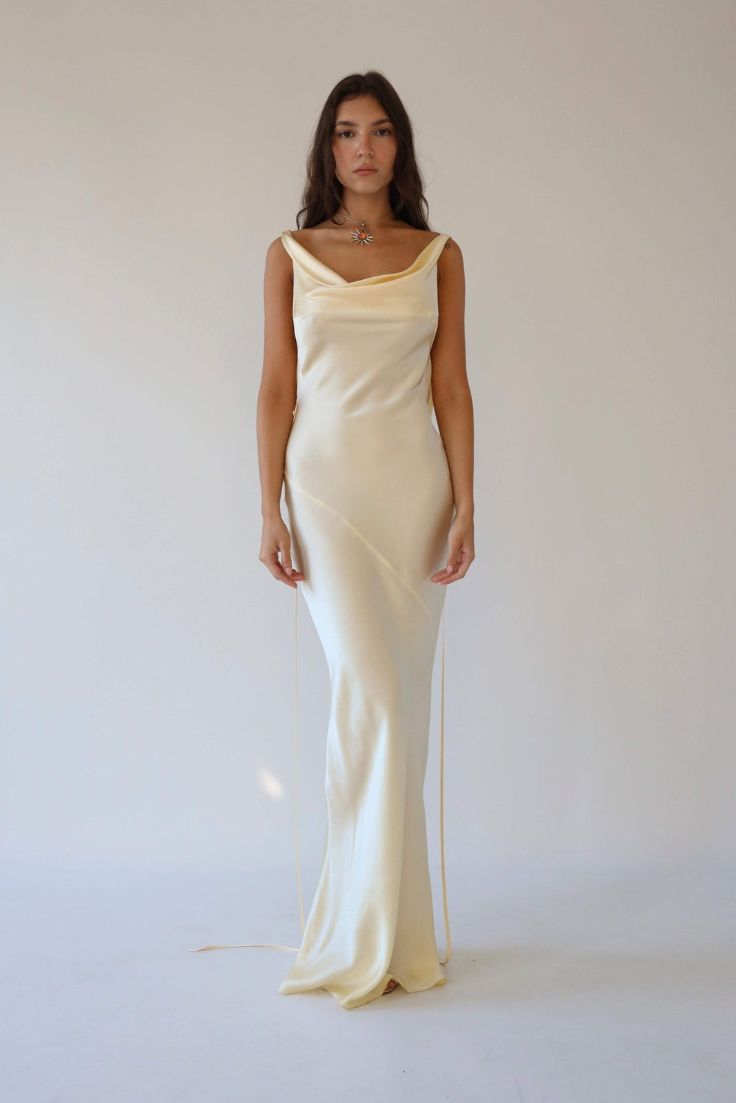 Woman wearing ivory silk cowl neck slip dress