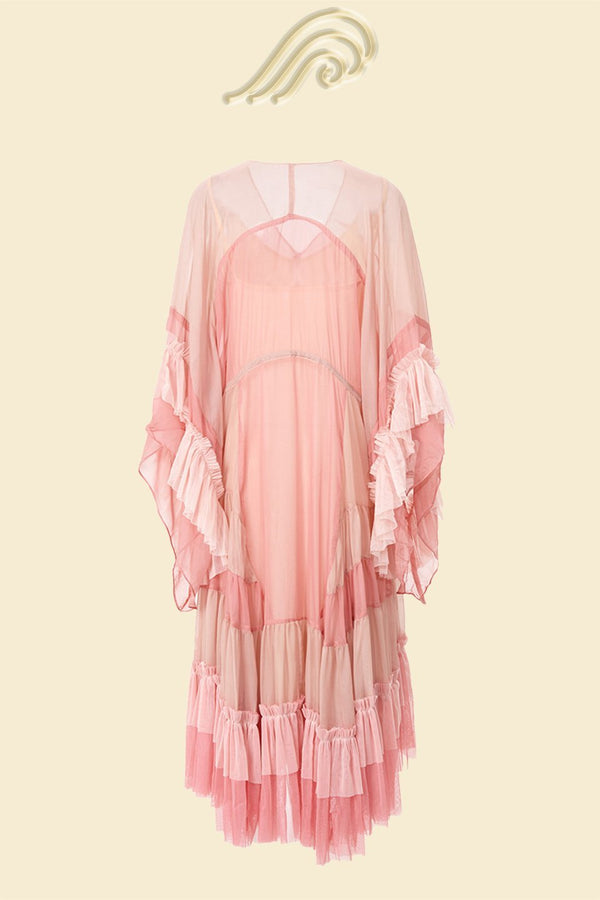 Woman in light pink chiffon tiered ruffle midi dress