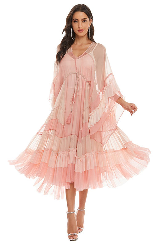 Woman in light pink chiffon tiered ruffle midi dress