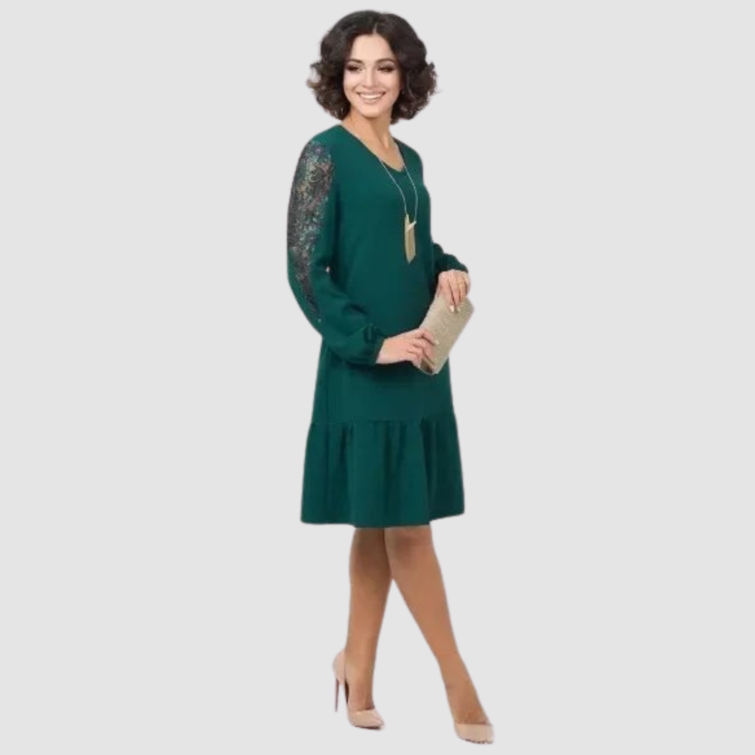 Dark Green - A woman wearing a navy blue knee-length shift dress with long bishop sleeves featuring sheer lace panels, a V-neckline, and a ruffled flounce hem.