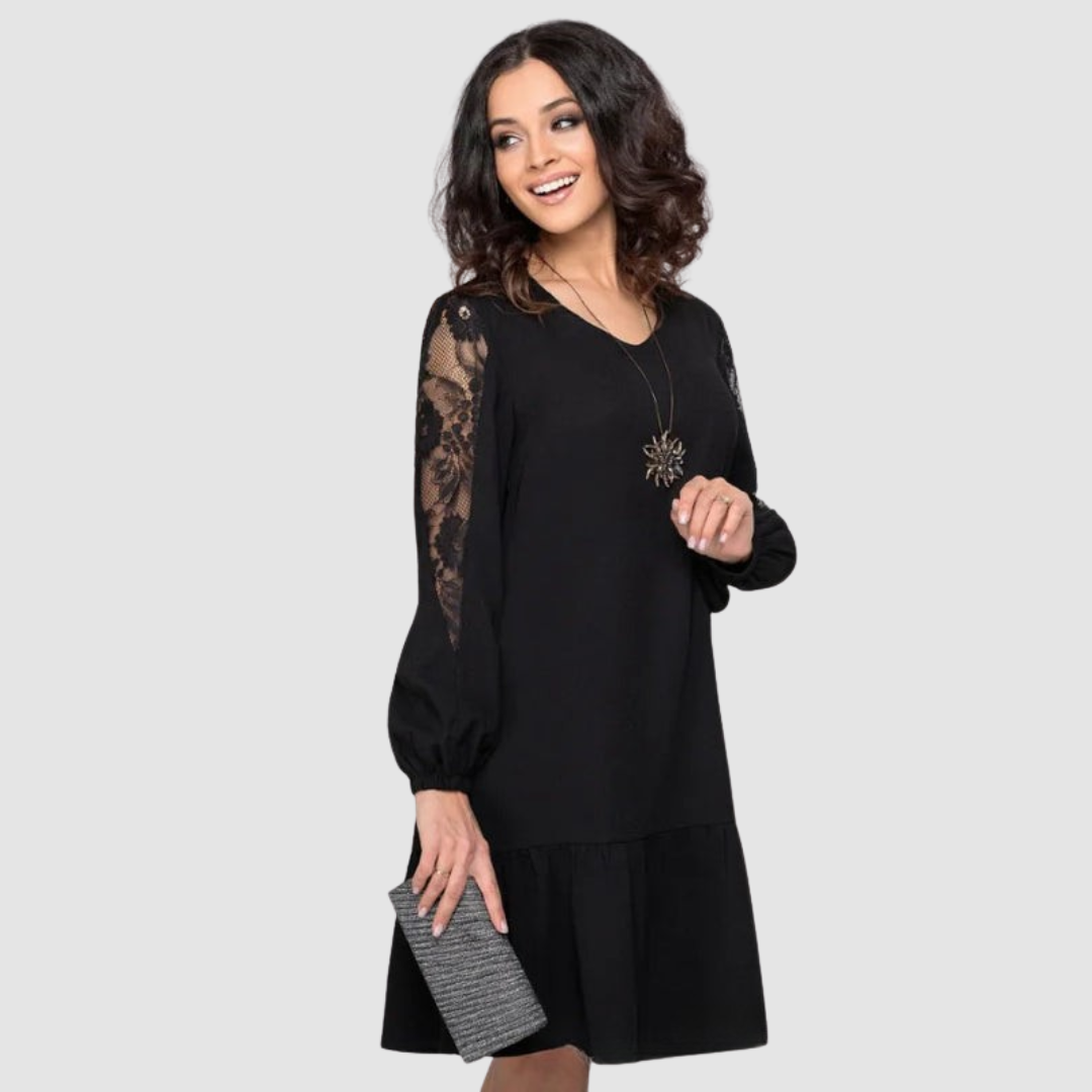 Dark Green - A woman wearing a navy blue knee-length shift dress with long bishop sleeves featuring sheer lace panels, a V-neckline, and a ruffled flounce hem.