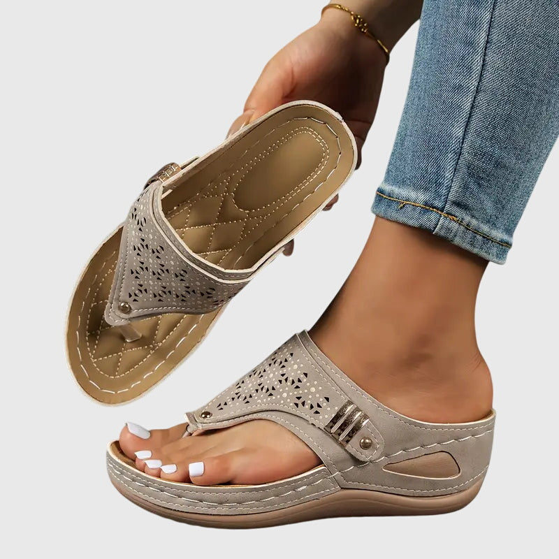 Khaki - Faux-leather wedge sandals featuring laser-cut upper detailing, a decorative side buckle, contoured stitched footbed, and contrast stitching along the sole