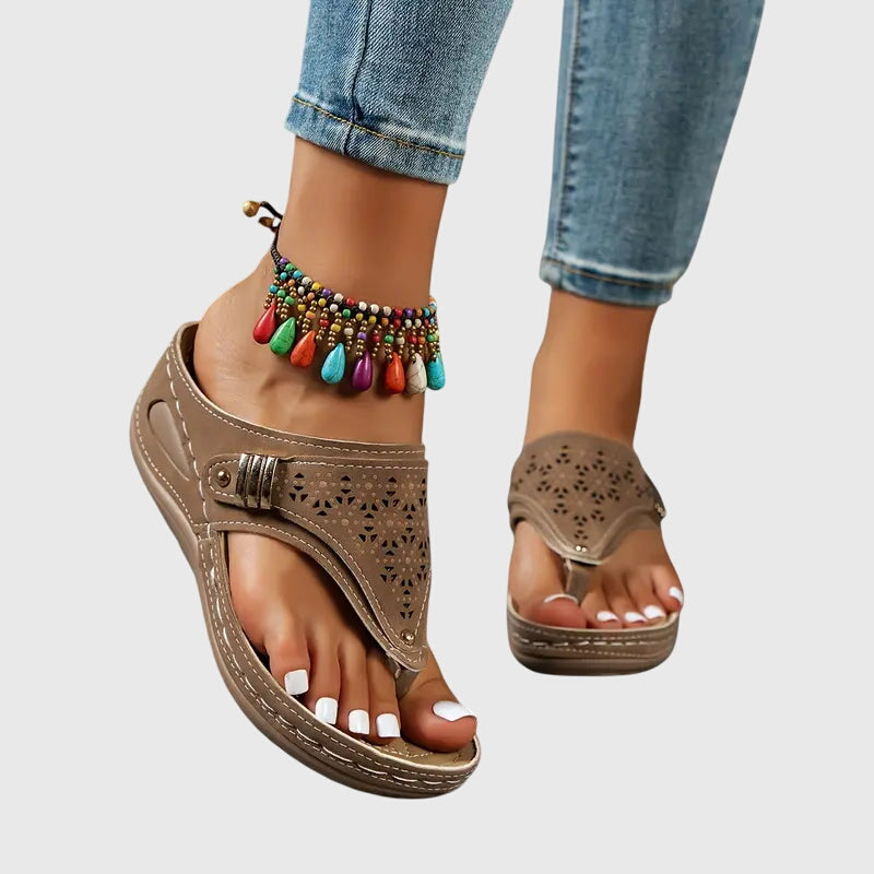 Khaki - Faux-leather wedge sandals featuring laser-cut upper detailing, a decorative side buckle, contoured stitched footbed, and contrast stitching along the sole