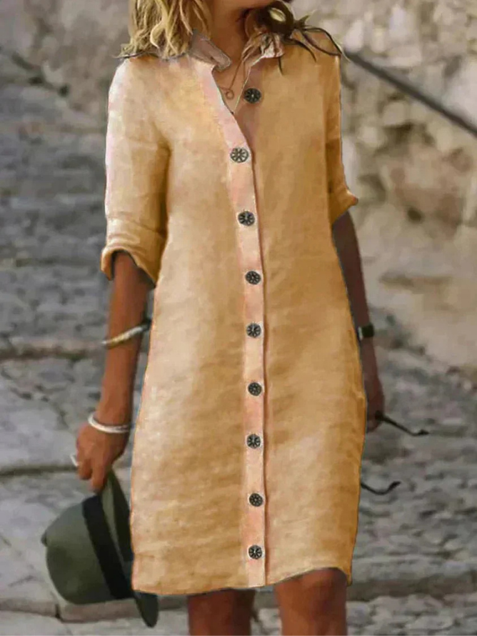 Khaki - Woman walking outdoors wearing a long-sleeve, button-front linen midi dress with a collar, holding a hat.
