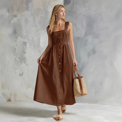 Brown - A woman modeling a chocolate brown linen-blend midi sundress with a square neckline, wide straps, and a button-down front, holding a woven straw tote bag.