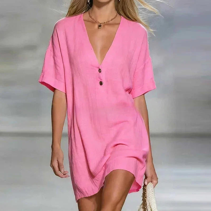 Pink - Woman wearing a textured linen short sleeve mini dress with a relaxed fit and partial button front detail