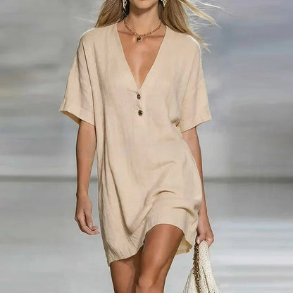 Linen - Woman wearing a textured linen short sleeve mini dress with a relaxed fit and partial button front detail