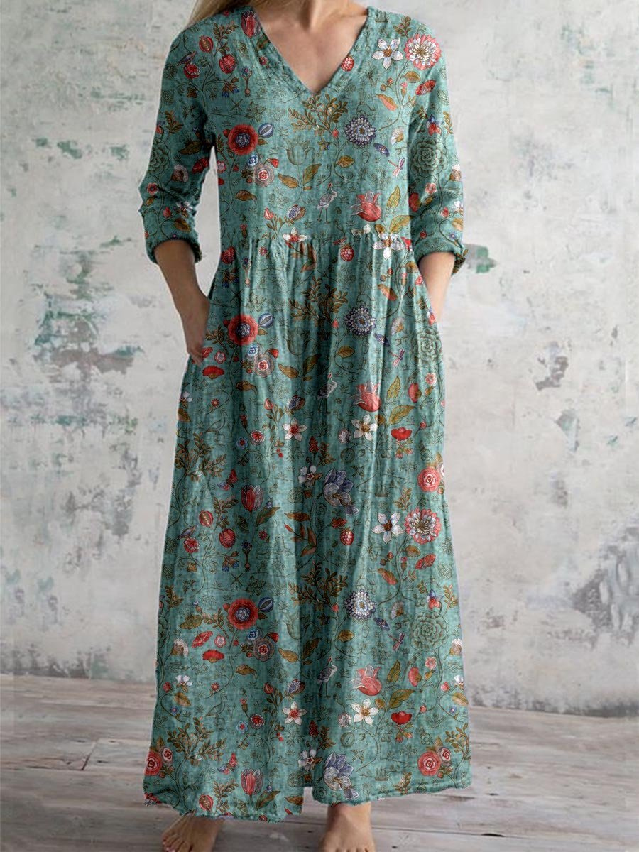 3XL - Woman wearing a long, textured floral maxi dress with 3/4 sleeves and hands resting in side pockets