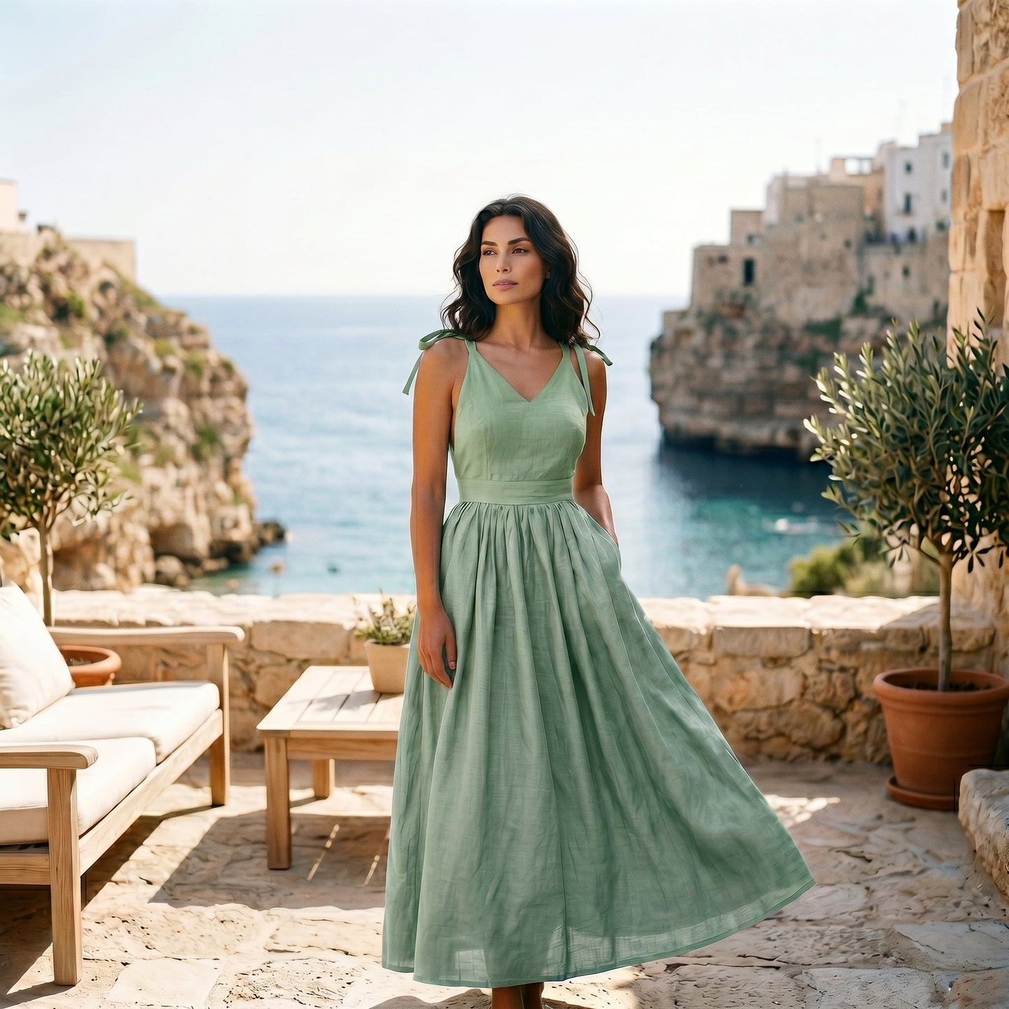 Black - Model wearing a solid woven maxi dress featuring tie-shoulder straps, a fitted waist, and a full sweeping skirt against a white studio background.