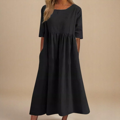 Black - Woman wearing a solid babydoll midi dress with half sleeves, a gathered high waist, and side pockets.
