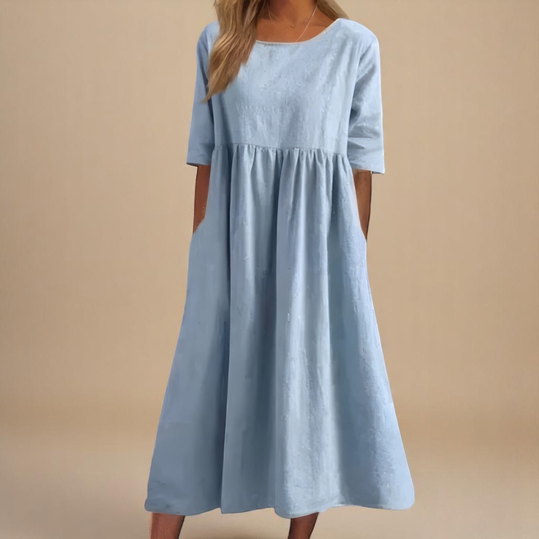 Light Blue - Woman wearing a solid babydoll midi dress with half sleeves, a gathered high waist, and side pockets.
