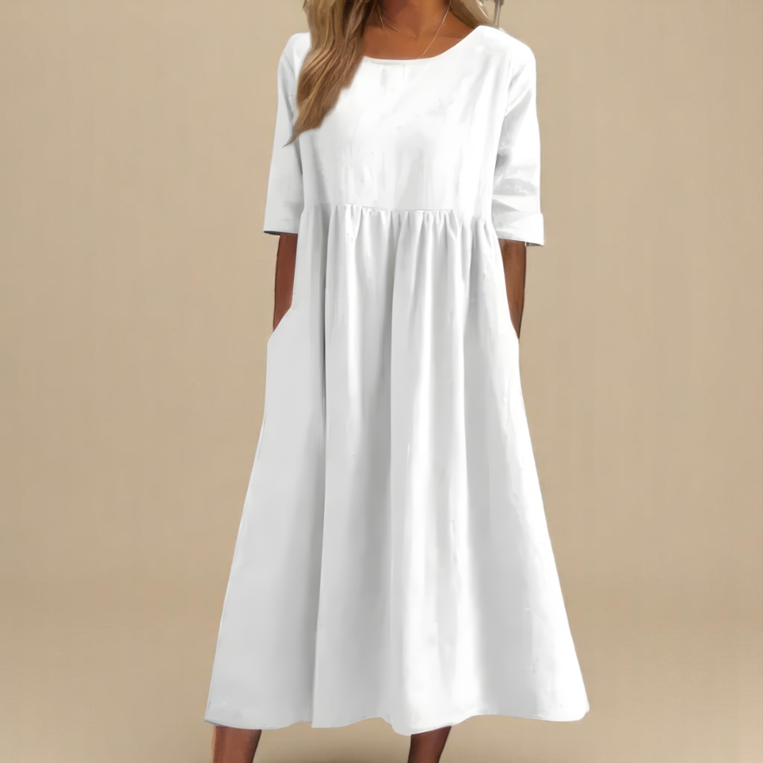 White - Woman wearing a solid babydoll midi dress with half sleeves, a gathered high waist, and side pockets.