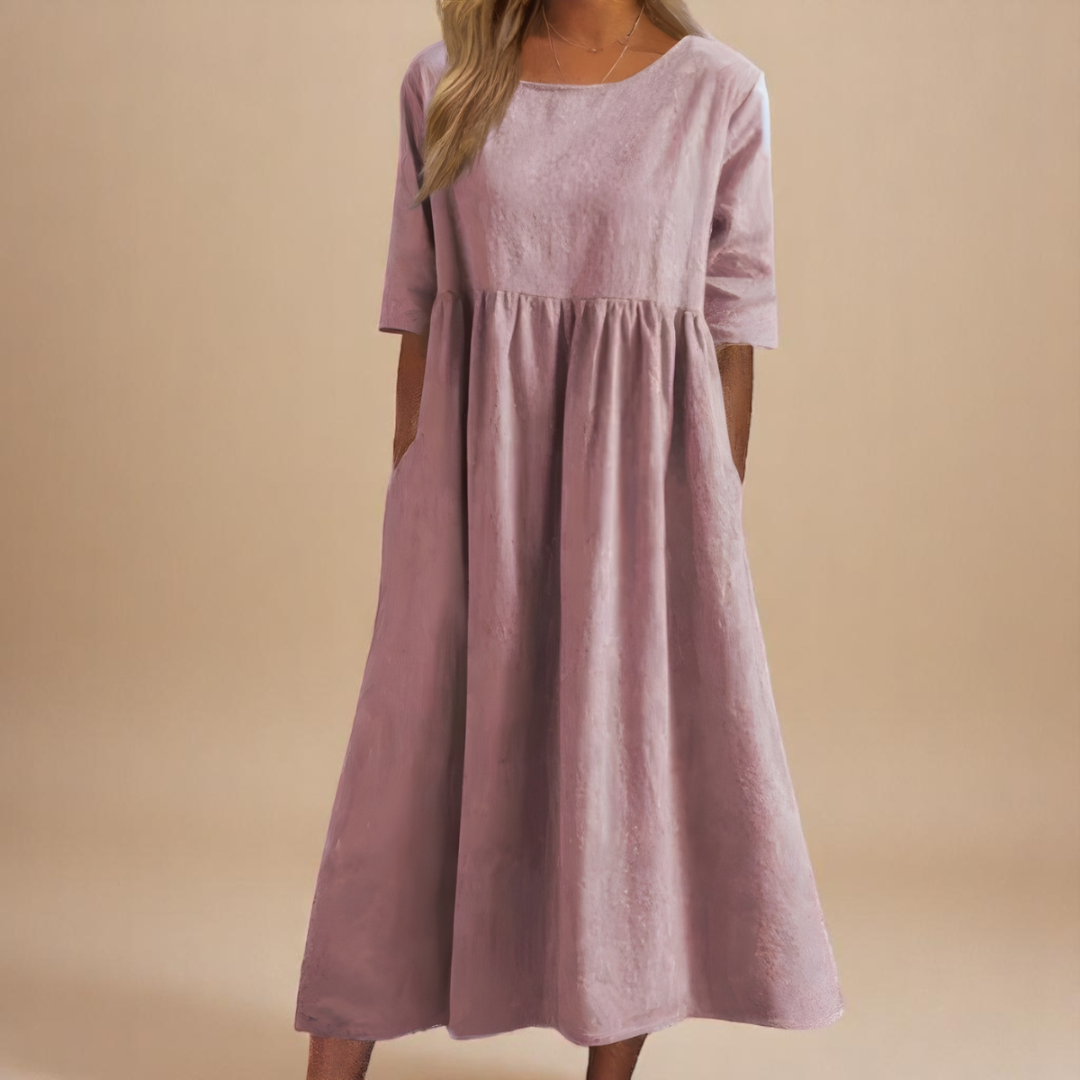 Dusty Pink - Woman wearing a solid babydoll midi dress with half sleeves, a gathered high waist, and side pockets.