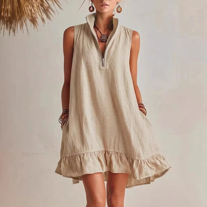 Khaki - Women's sleeveless A-line mini dress in a textured fabric featuring a high neck with a half-zip closure, side pockets, and a ruffle hem