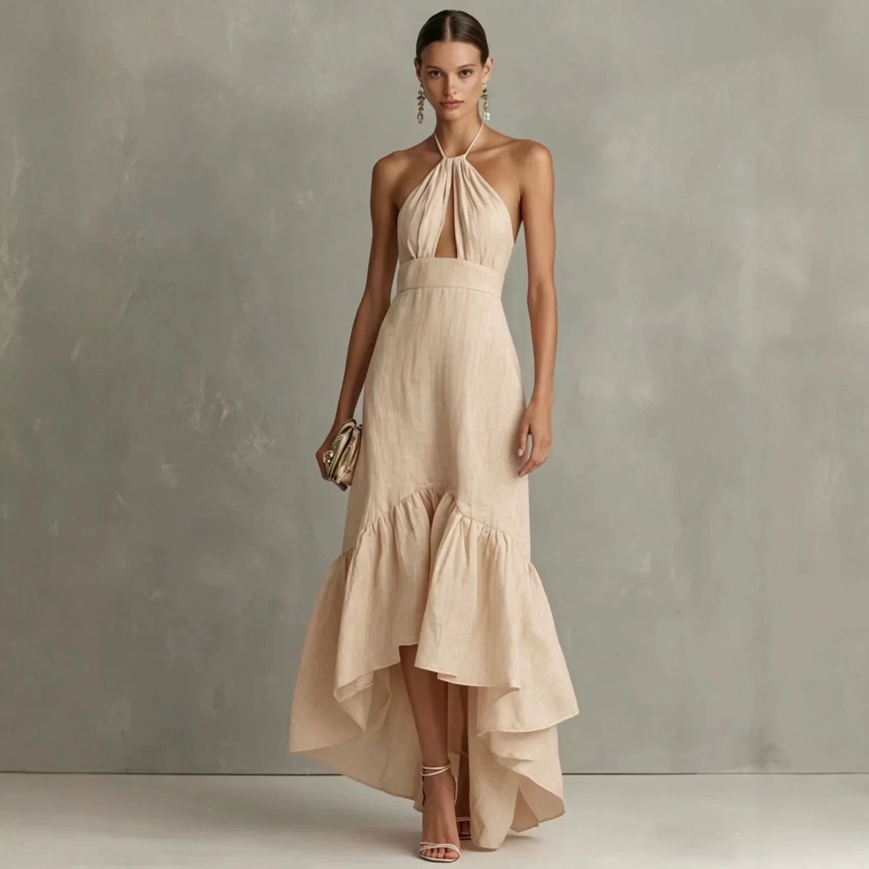 Apricot - A woman wearing a black linen-blend halter neck maxi dress with a front keyhole cutout, a fitted waist, and a dramatic ruffled high-low hemline.