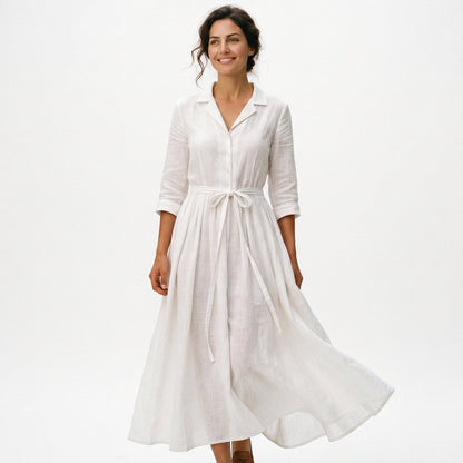 White - Model wearing a relaxed collared midi shirtdress with a front button placket, three-quarter sleeves, and an adjustable waist tie.