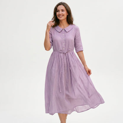 Purple - Model wearing a relaxed collared midi shirtdress with a front button placket, three-quarter sleeves, and an adjustable waist tie.