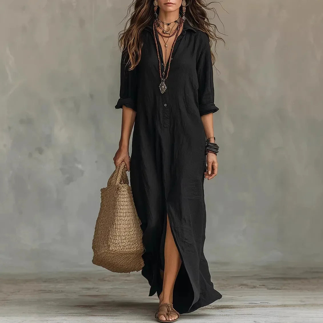Black - A woman wearing a relaxed-fit white linen maxi sundress with a collared V-neck, rolled sleeves, and a front slit, carrying a woven straw tote bag.