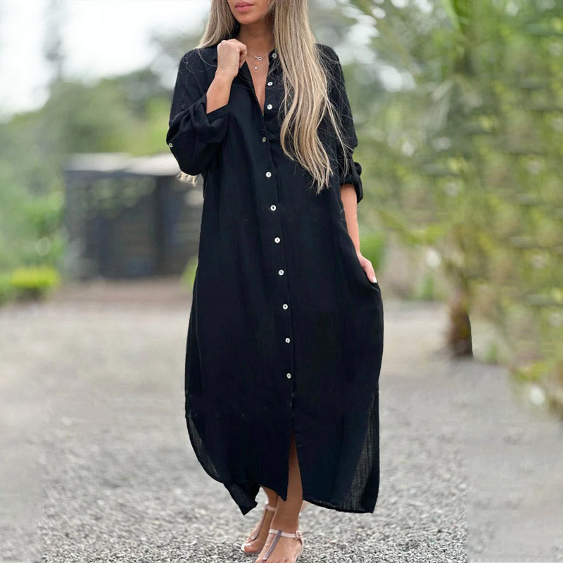 Black - A woman wearing a relaxed-fit, white linen-blend maxi shirt dress with long sleeves rolled up, featuring a button-down front, classic collar, and side pockets, standing outdoors.