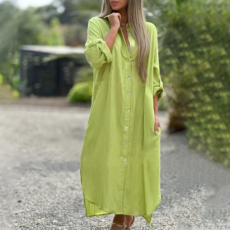 Green - A woman wearing a relaxed-fit, white linen-blend maxi shirt dress with long sleeves rolled up, featuring a button-down front, classic collar, and side pockets, standing outdoors.