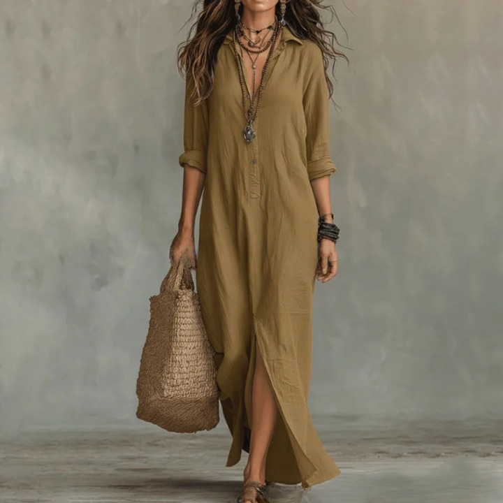 Khaki - A woman wearing a relaxed-fit white linen maxi sundress with a collared V-neck, rolled sleeves, and a front slit, carrying a woven straw tote bag.