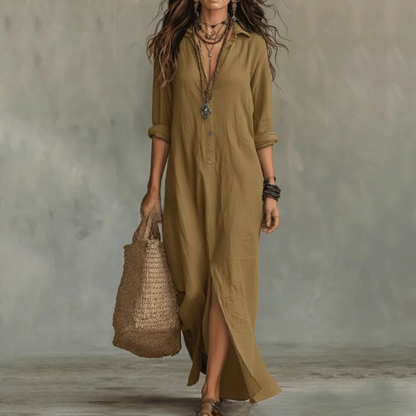 Khaki - A woman wearing a relaxed-fit white linen maxi sundress with a collared V-neck, rolled sleeves, and a front slit, carrying a woven straw tote bag.