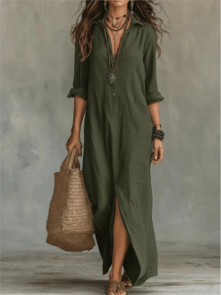 Army Green - A woman wearing a relaxed-fit black linen maxi sundress with a collared neckline, rolled sleeves, and a front slit, carrying a woven straw tote bag.