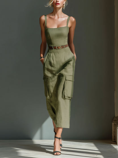 Model wearing a sleeveless square-neck midi dress with a fitted bodice, belted waist, and large cargo pockets on the skirt, styled with strappy heels.